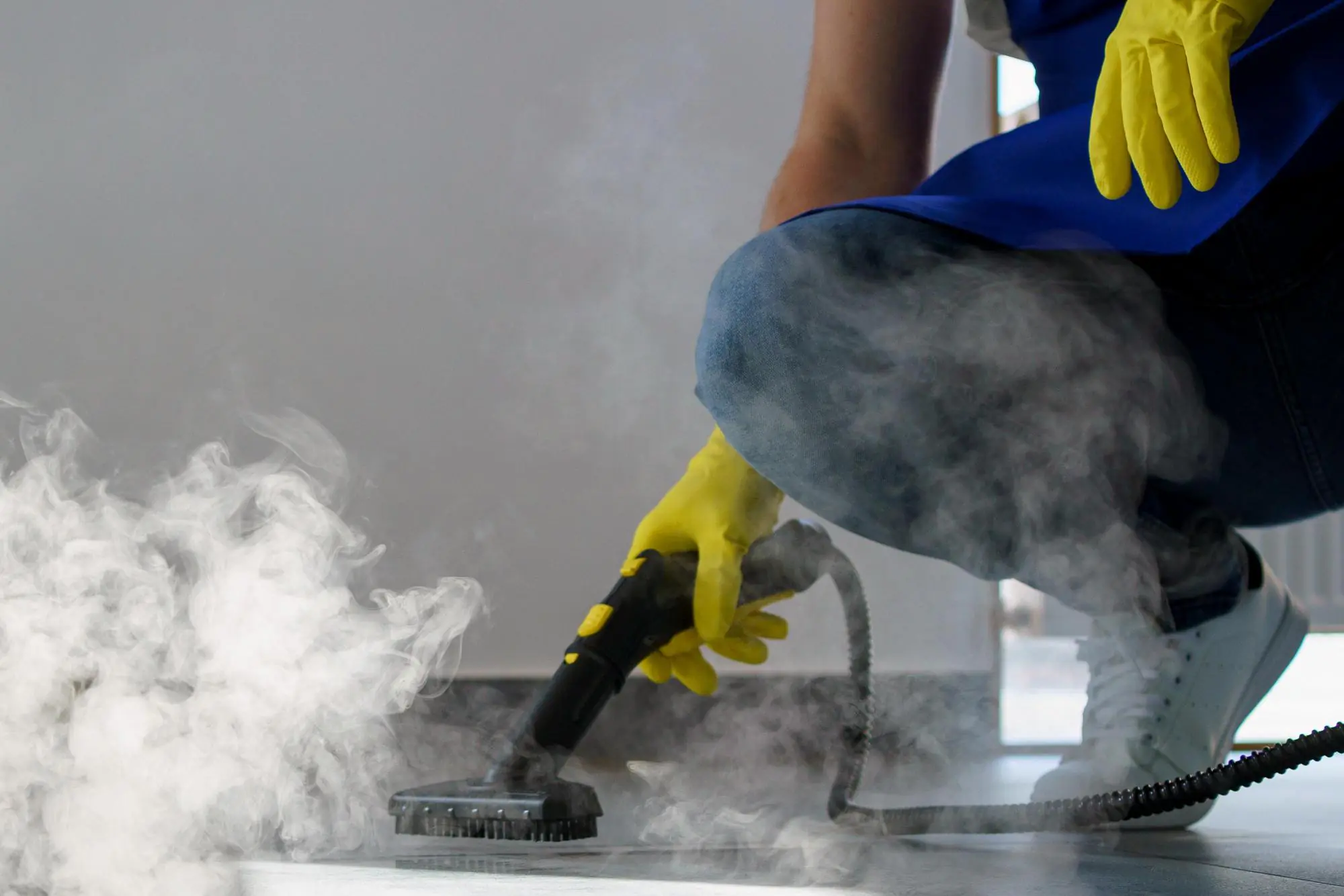 Professional cleaner using steam cleaner for office cleaning services. Eco-friendly disinfection and sanitation of surfaces.