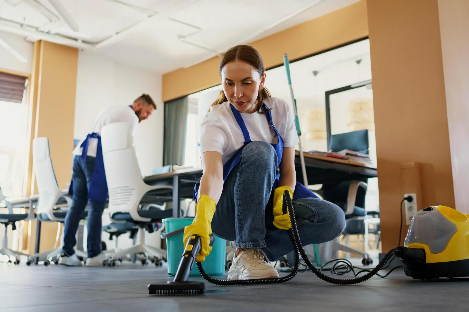 Professional cleaning service: woman using vacuum cleaner in office. Commercial cleaning services for businesses.